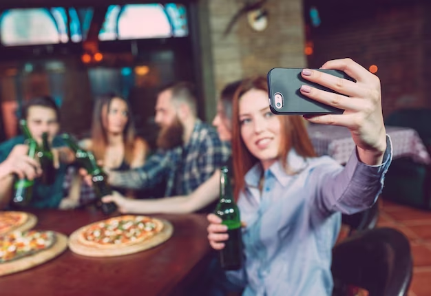 A Girl Capturing Herself With Friends &  Food