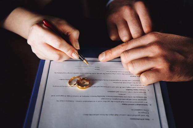 Photo marriage contract sign concept. man and woman signing documents.