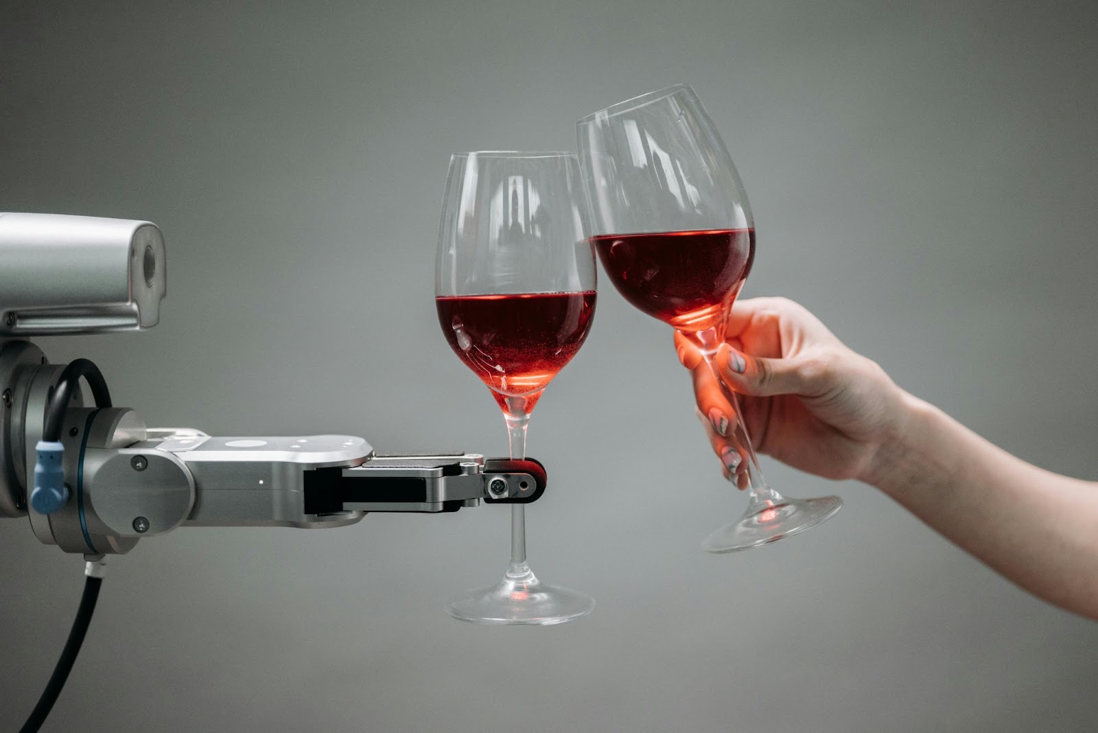 Robot holding a beverage it made as a hotel robot bartender