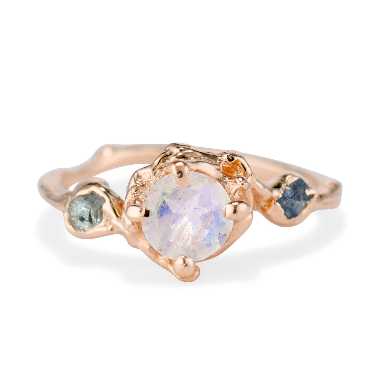 The Naples Moonstone Trio Ring. A polished round moonstone sits beside two rough Montana sapphires and is set on a nature inspired band. 