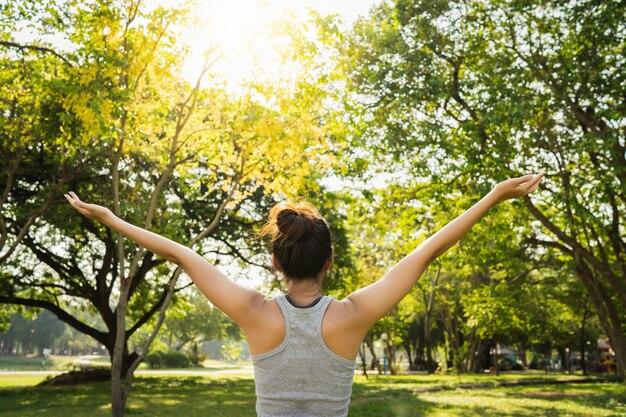 Free photo healthy young asian runner woman warm up the body stretching before exercise