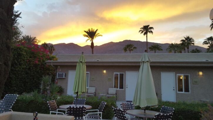 photo of the sunset from the outdoor pool and lounge area for gay male clothing optional resort inndule located in palm springs california