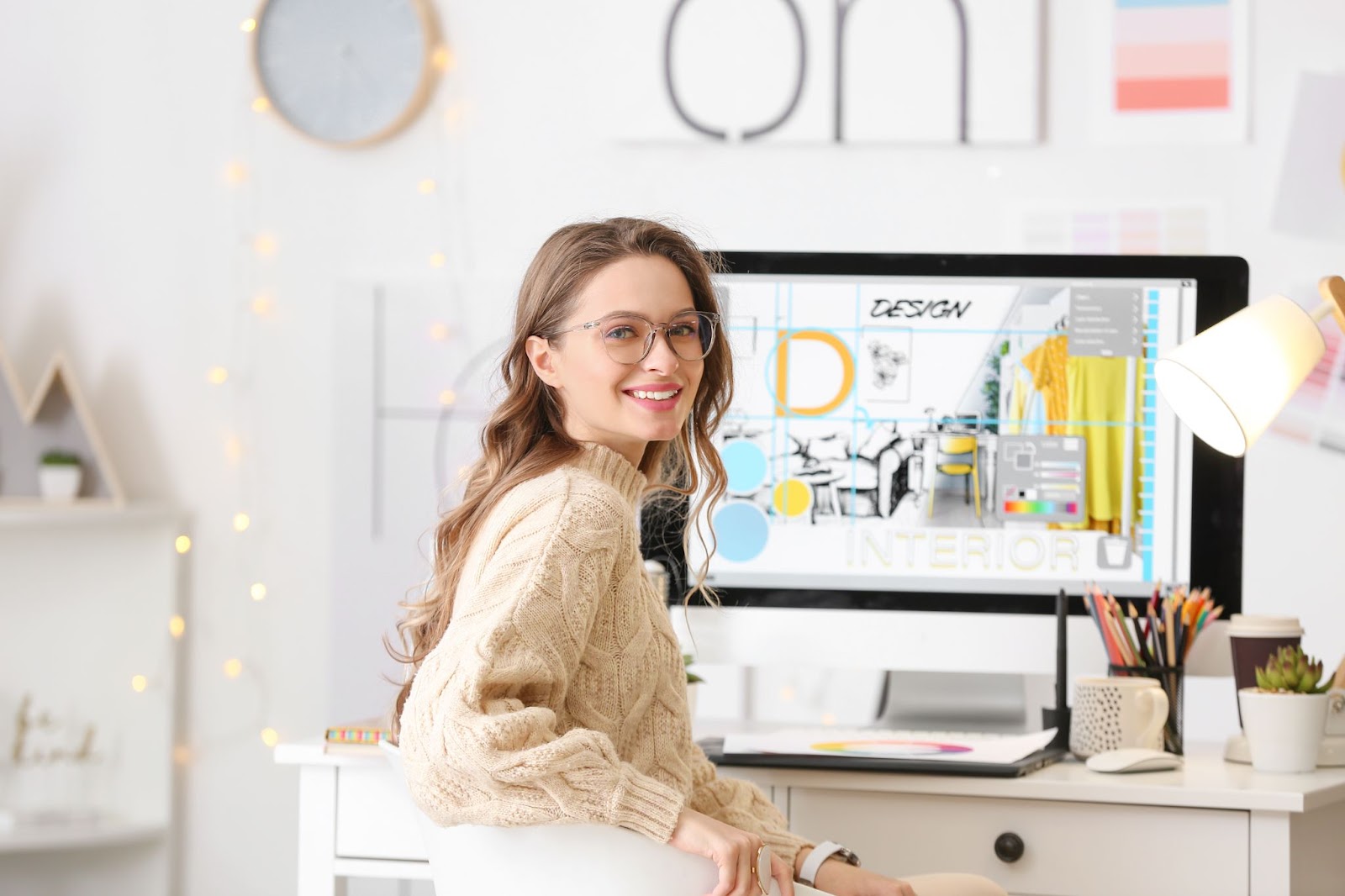 Young woman graphic designer at desk