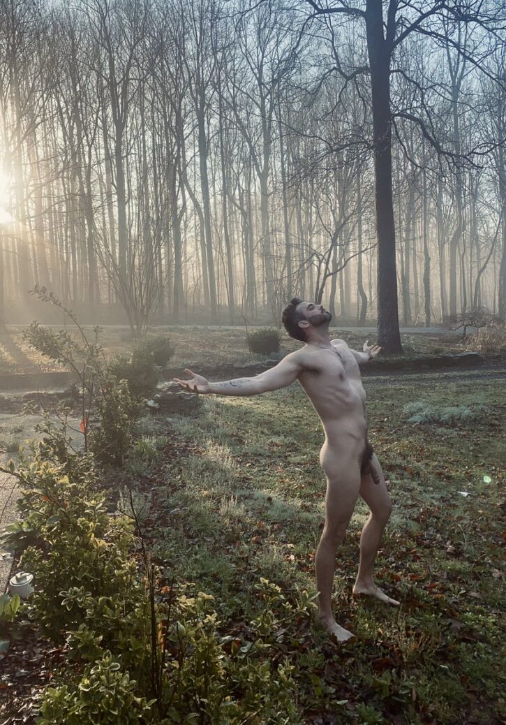 Kae ecstatic posing naked in the forest with his arms held out