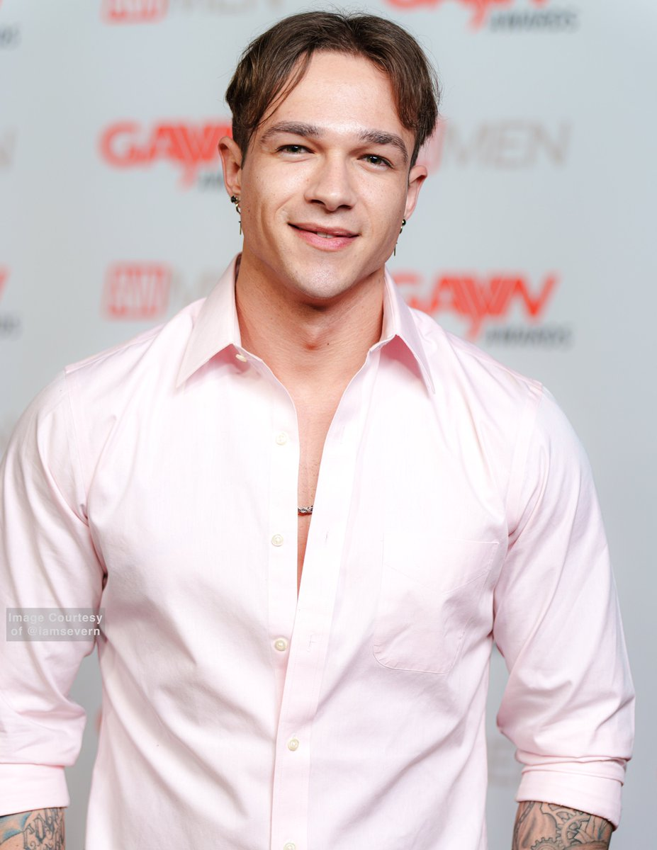 Jayden Marcos posing on the Gayvn awards red carpet in a white dress shirt
