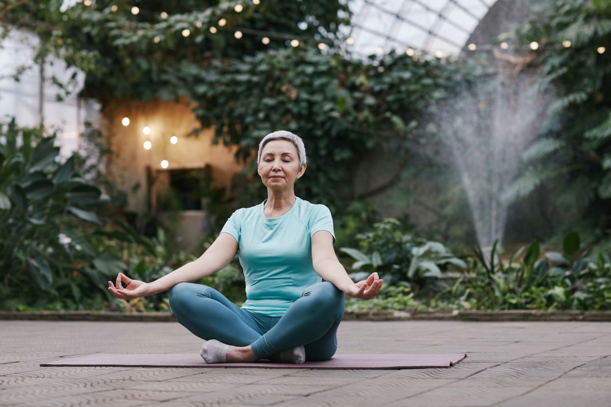  a woman doing yoga in a garden