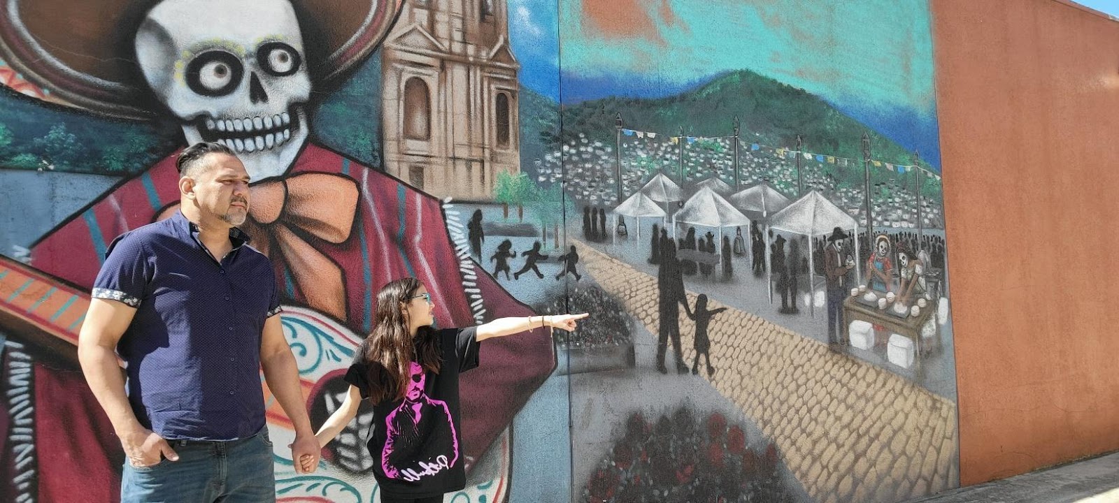 A person pointing at a mural

Description automatically generated