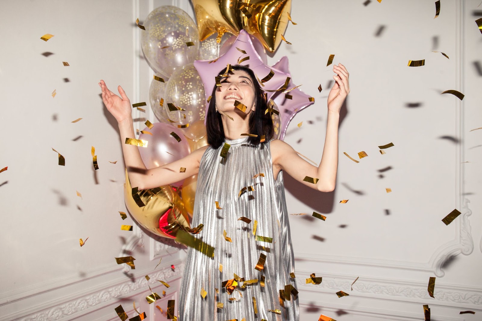 Some of the best New Year's gifts, a stylish dress, balloons, and confetti