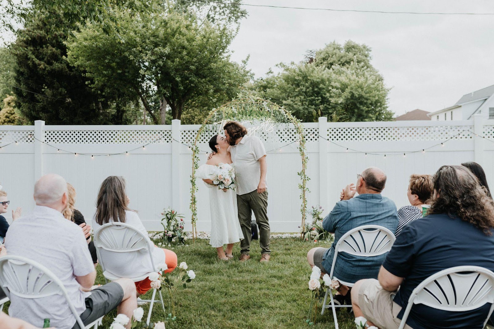 Couple kissing after their backyard micro wedding ceremony