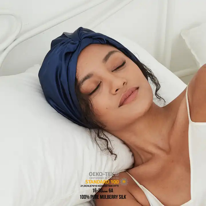 Woman sleeping with her head wrapped in a silk scarf