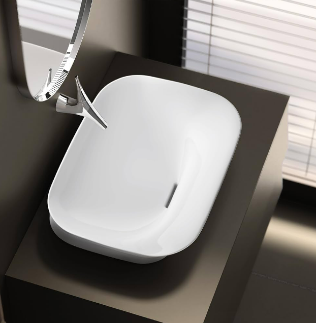 A white sink with a round mirror

Description automatically generated