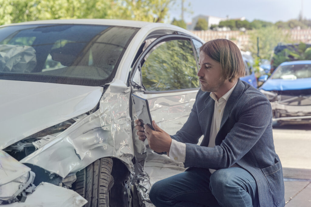 insurance adjuster taking picture of damage from a car accident in Indianapolis, Indiana