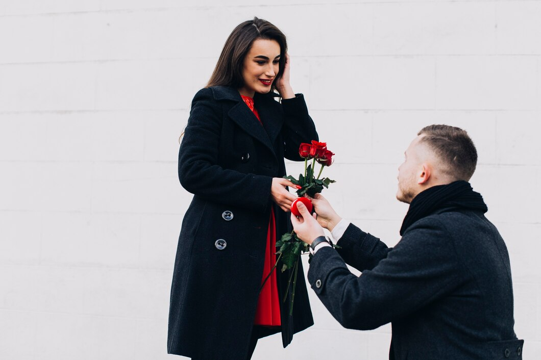 A man proposing and giving flowers to his girlfriend.