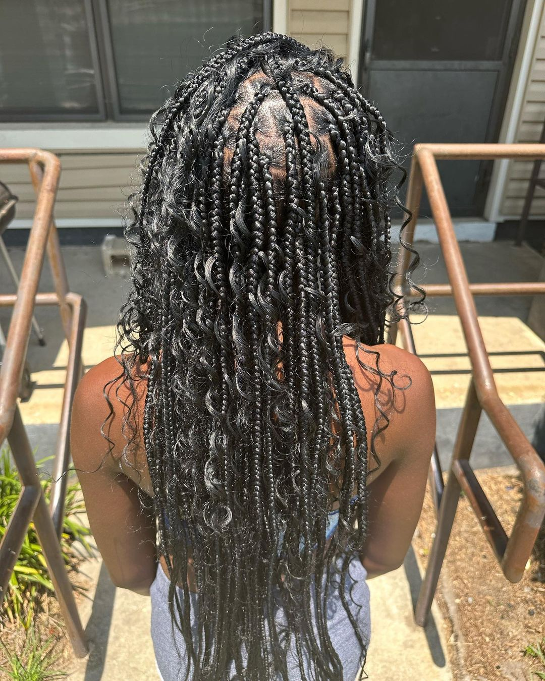 Picture of a lady chilling rocking the gorgeous braids 