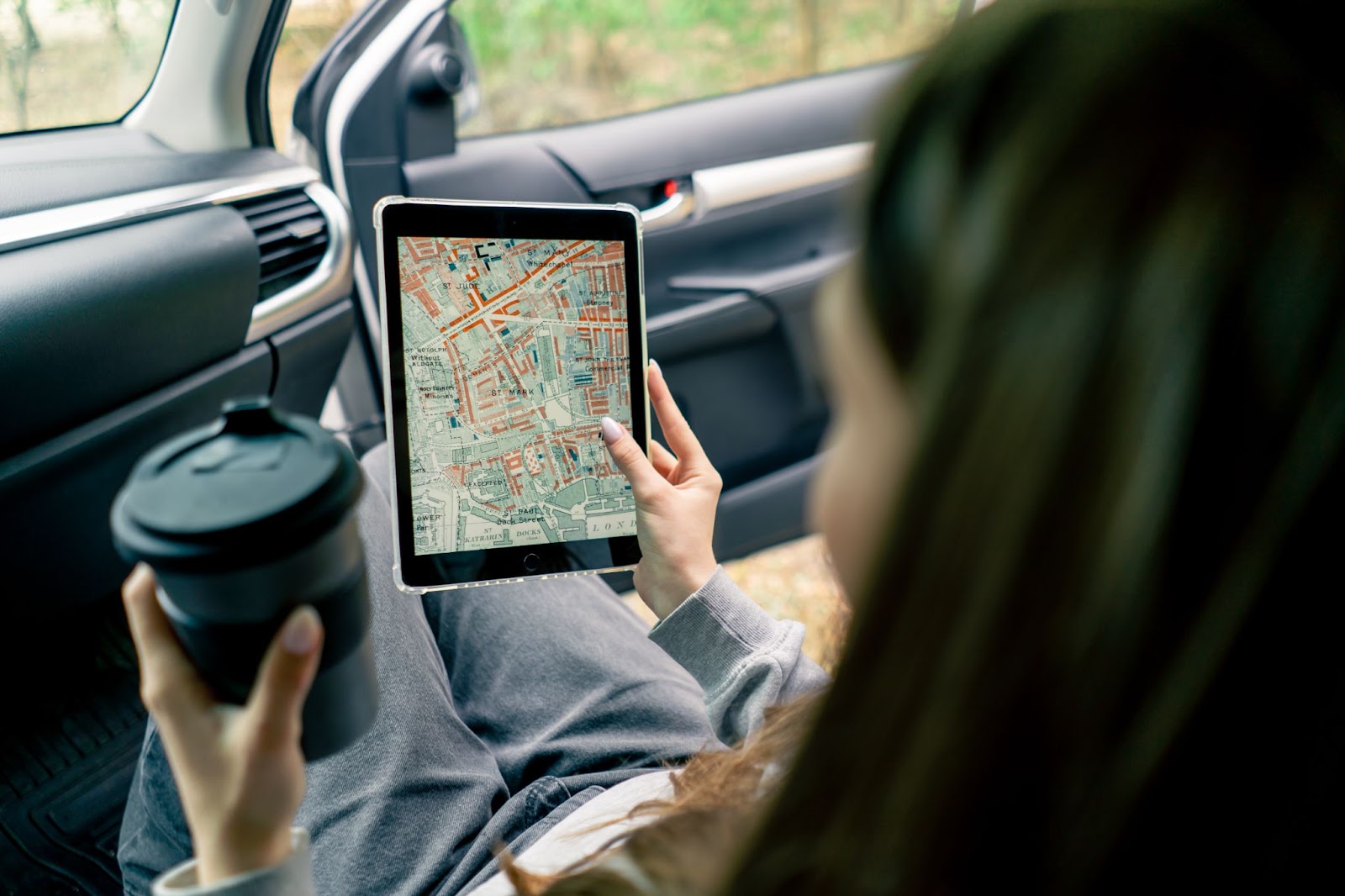  girl is using a tablet to monitor a route. 