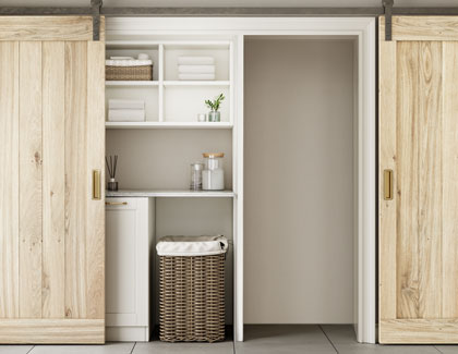 A closet with sliding doors and shelves, providing organized storage space for clothes and other items.