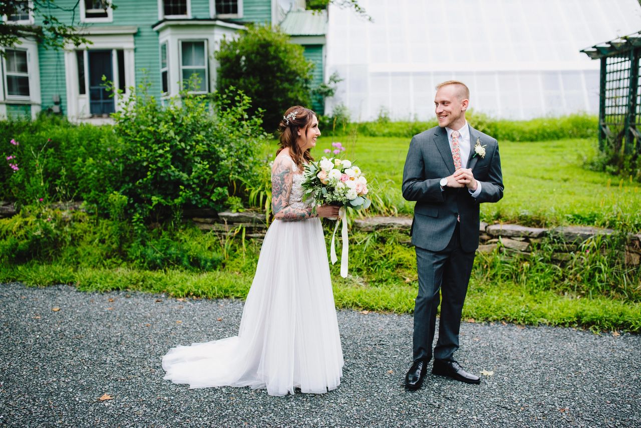 Groom turning to look at bride