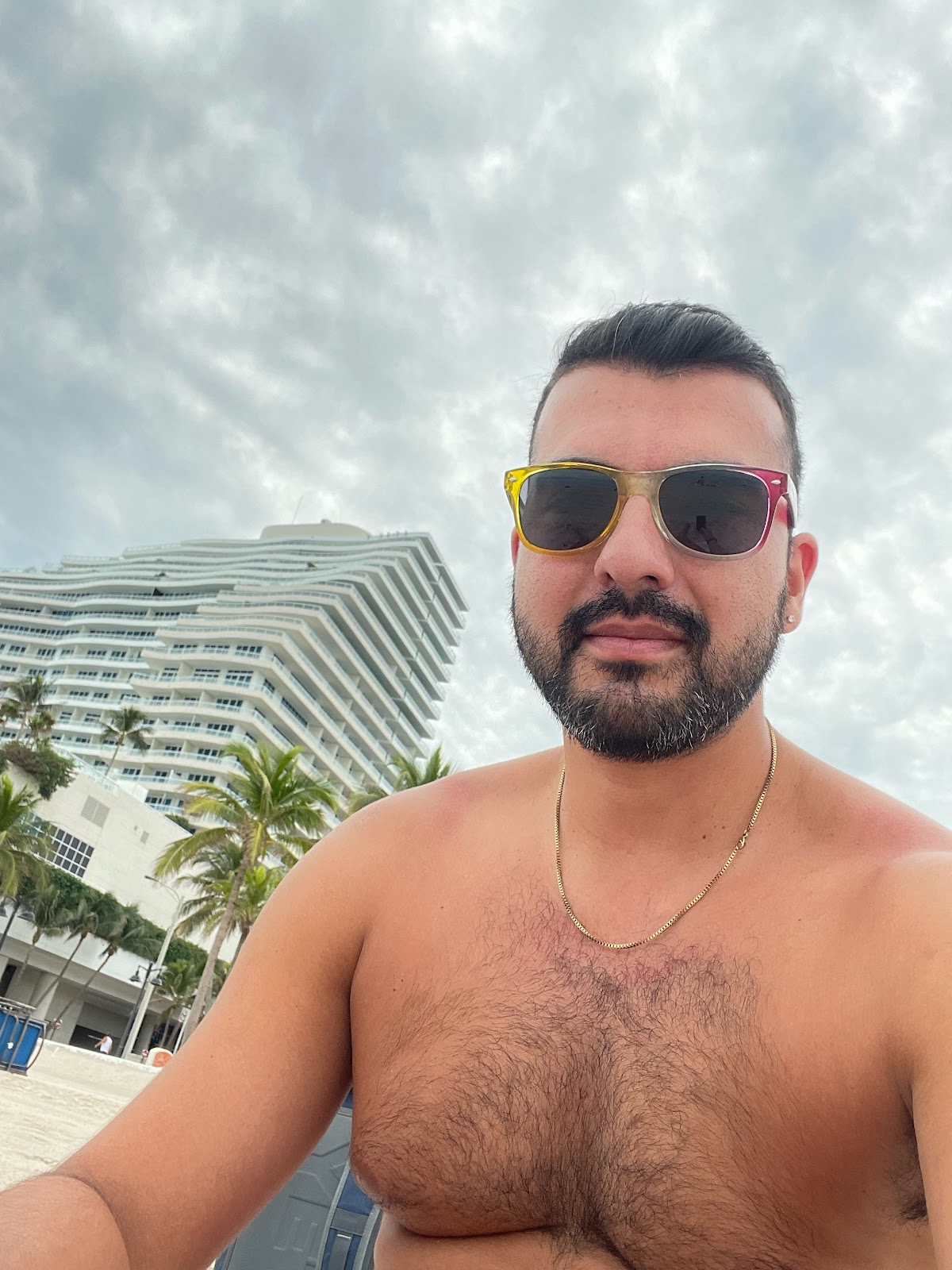 gay male shirtless with hairy chest chilling outside in the fort lauderdale weather
