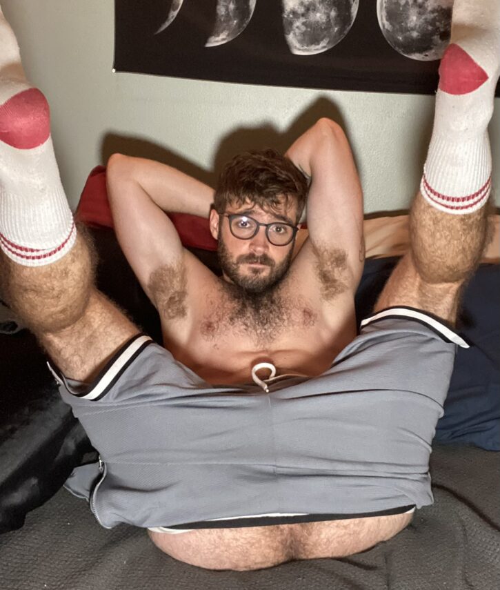 Forest Cliff shirtless with his legs in the air wearing white athletic socks with his athletic shorts pulled down to reveal his hairy ass