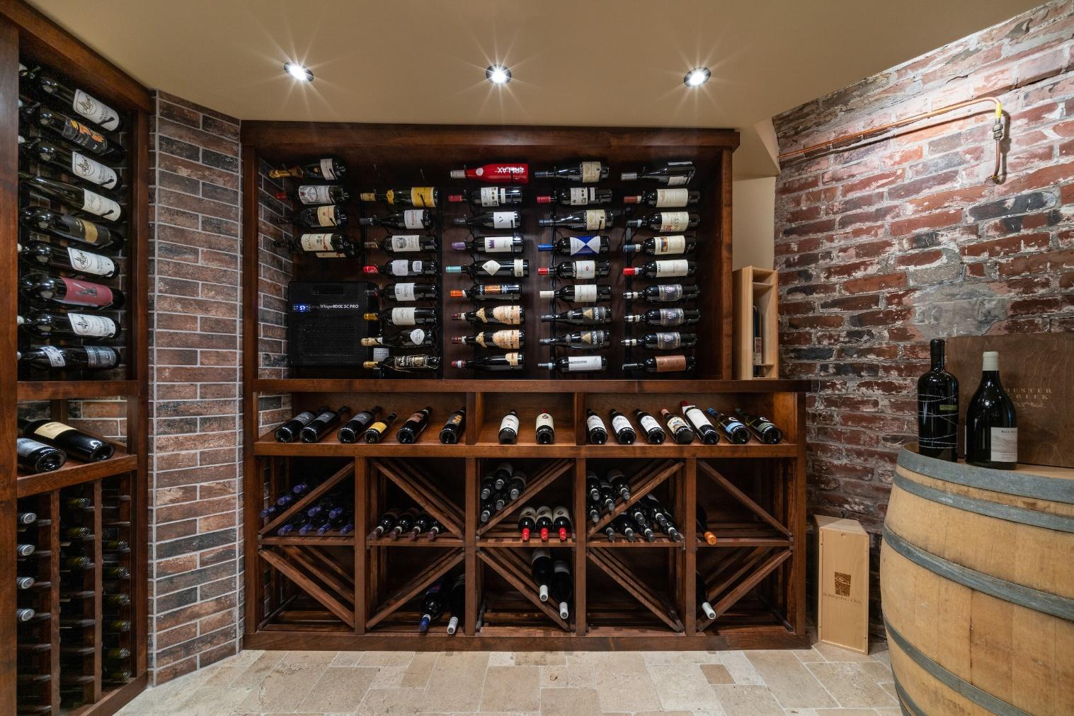 A wine rack with bottles on itDescription automatically generated