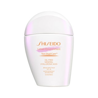 Shiseido Urban Environment OilFree Mineral Sunscreen SPF 42 flat white bottle of sunscreen with rounded cap on white...
