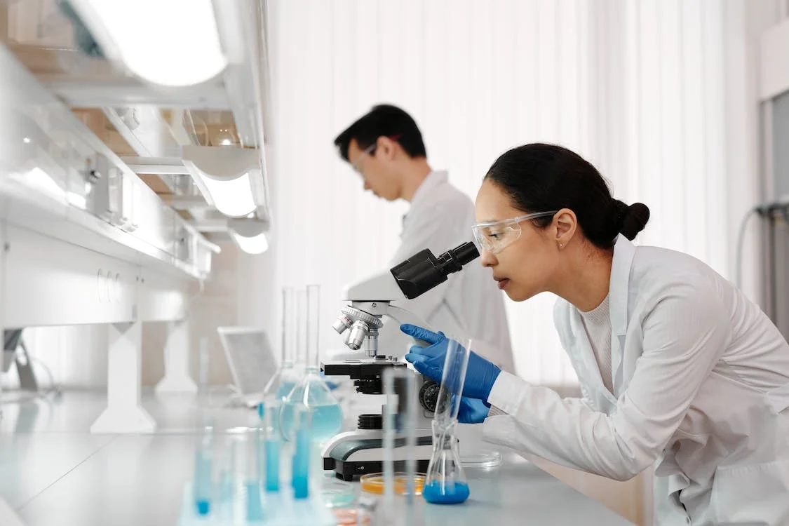 woman using the microscope in the lab