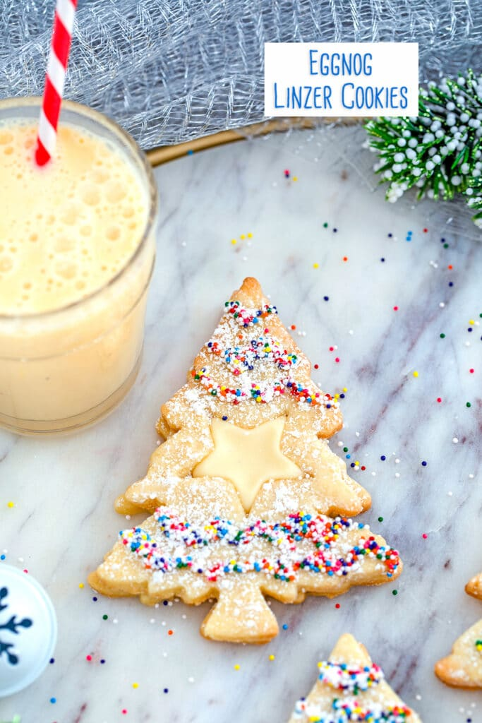 eggnog linzer cookies with glass of eggnog
