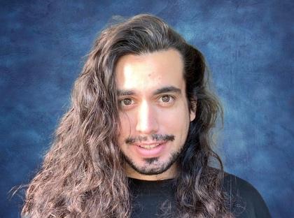 A person with long hair and beard

Description automatically generated