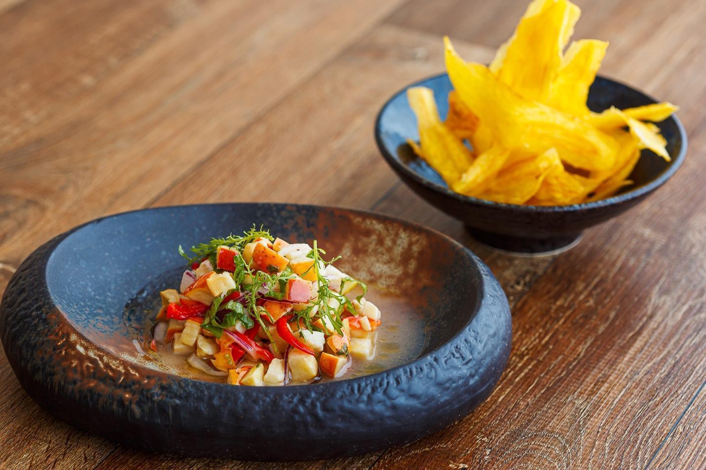 A bowl of food next to a bowl of french fries Description automatically generated with medium confidence