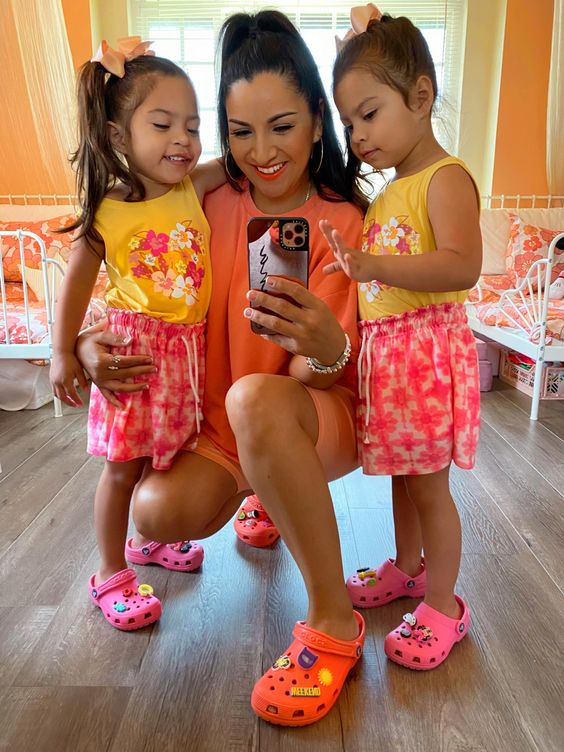 Picture showing a mum  and two daughters rocking the iconic crocs