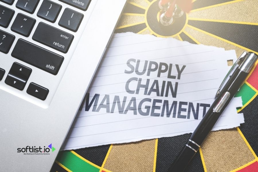 Supply Chain Management written on notepad with computer and pen.