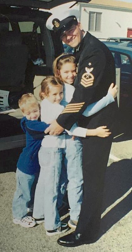 Jeffrey Garber hugs his three kids, in uniform