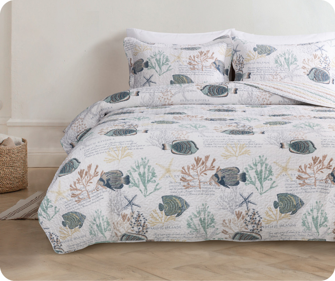 Our aquatic Marella Cotton Quilt Set shown on a bed.
