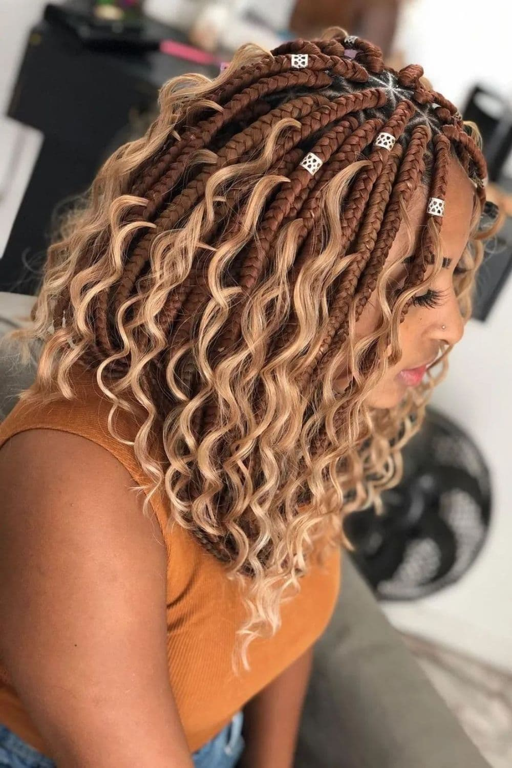 Side view of a lady rocking shoulder- length bohemian braids