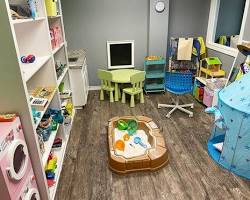 child playing with a therapist in a playroom