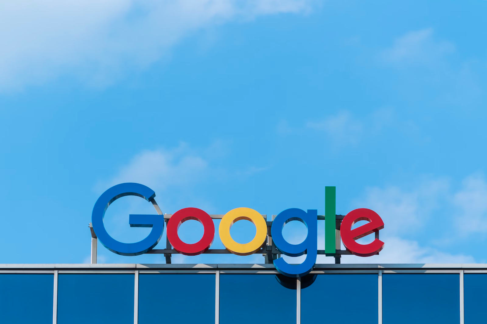 Google sign on top of a building with the blue sky as background