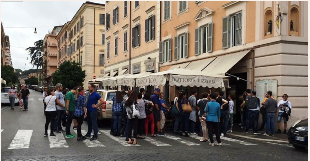 A group of people standing in front of a food truck

Description automatically generated