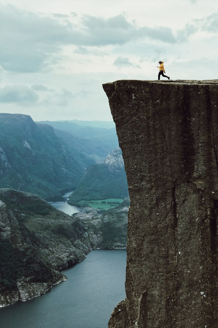 A person running towards the edge of the cliff.
