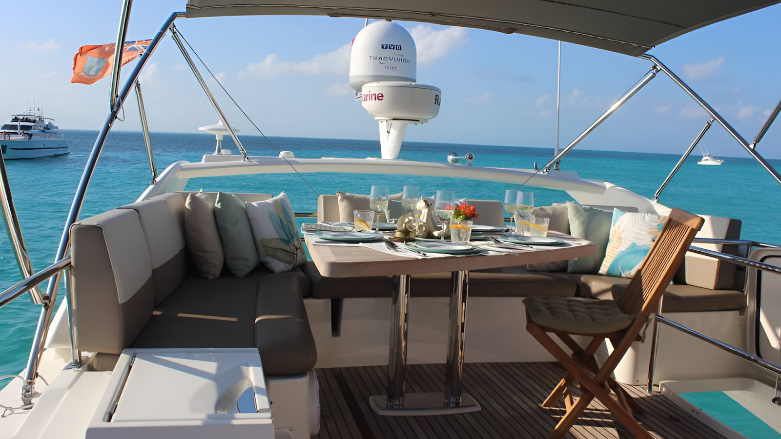 A dining table set up on the deck of a yacht