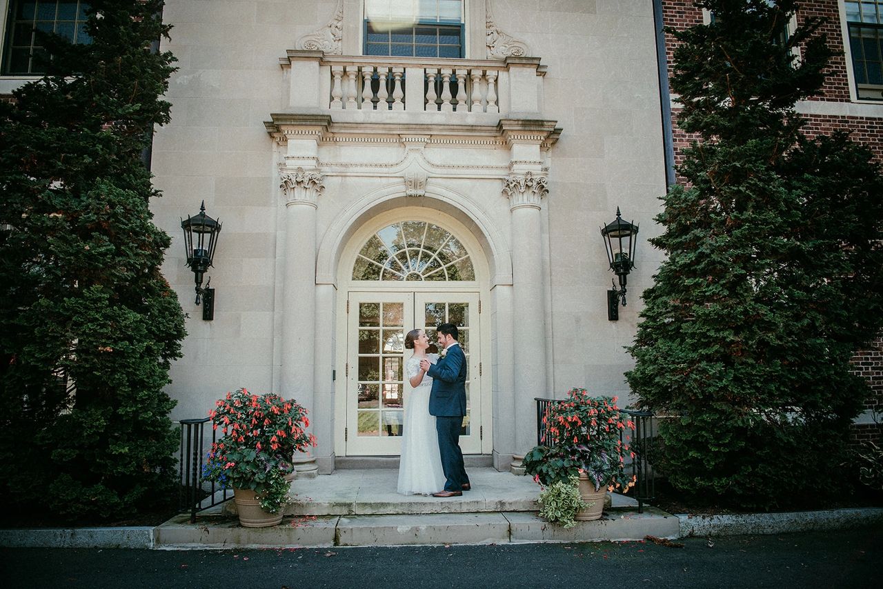 Bride and Groom dancing in front of door