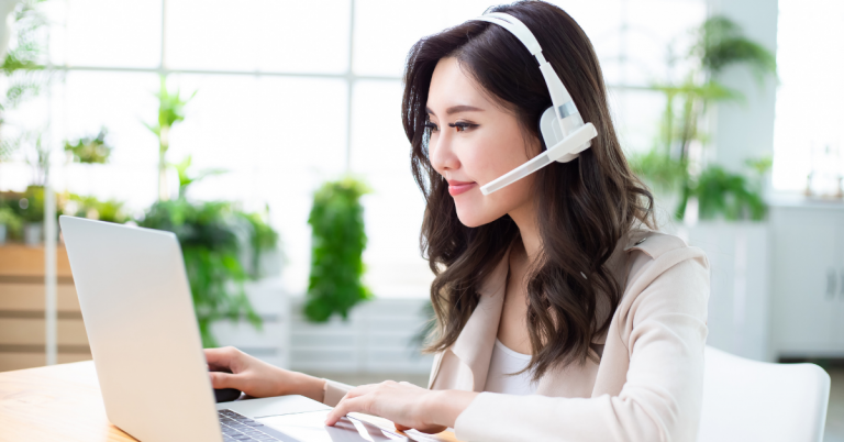 A person wearing a headset and looking at a laptop symbolyzing an array of telemarketing services