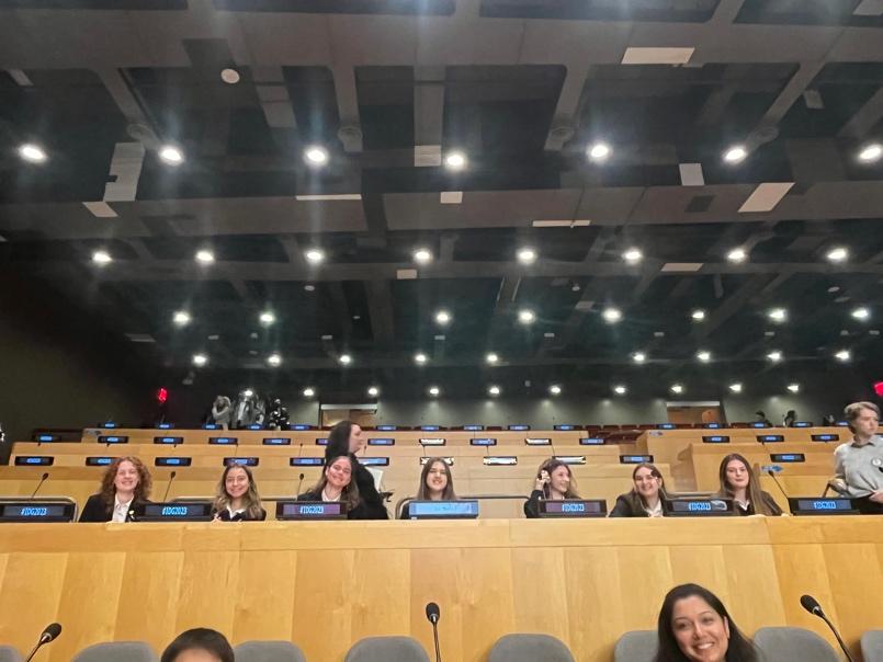 A group of women sitting in a row in a auditorium Description automatically generated