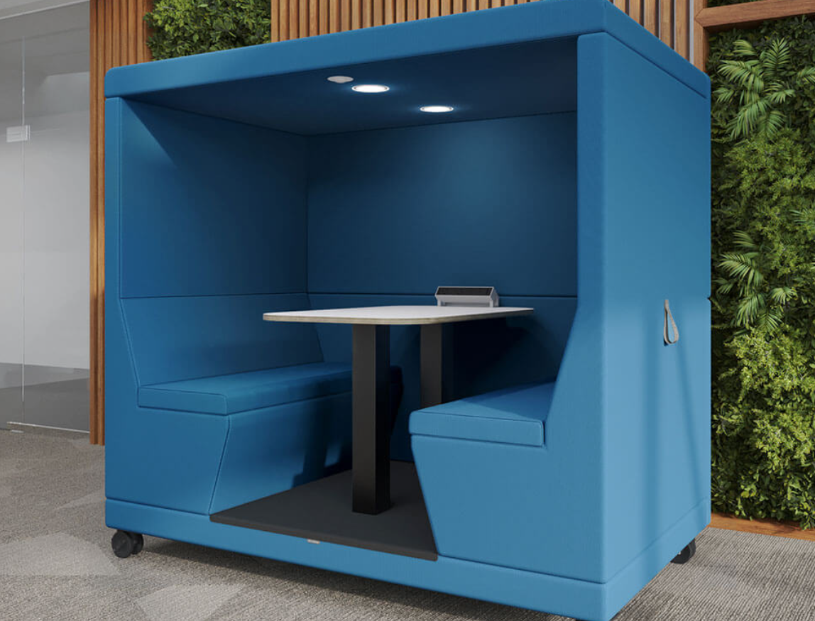 Blue sound-absorbing 4 seater mobile pod with work table.