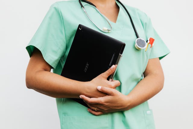 A nurse who works remotely with a laptop.