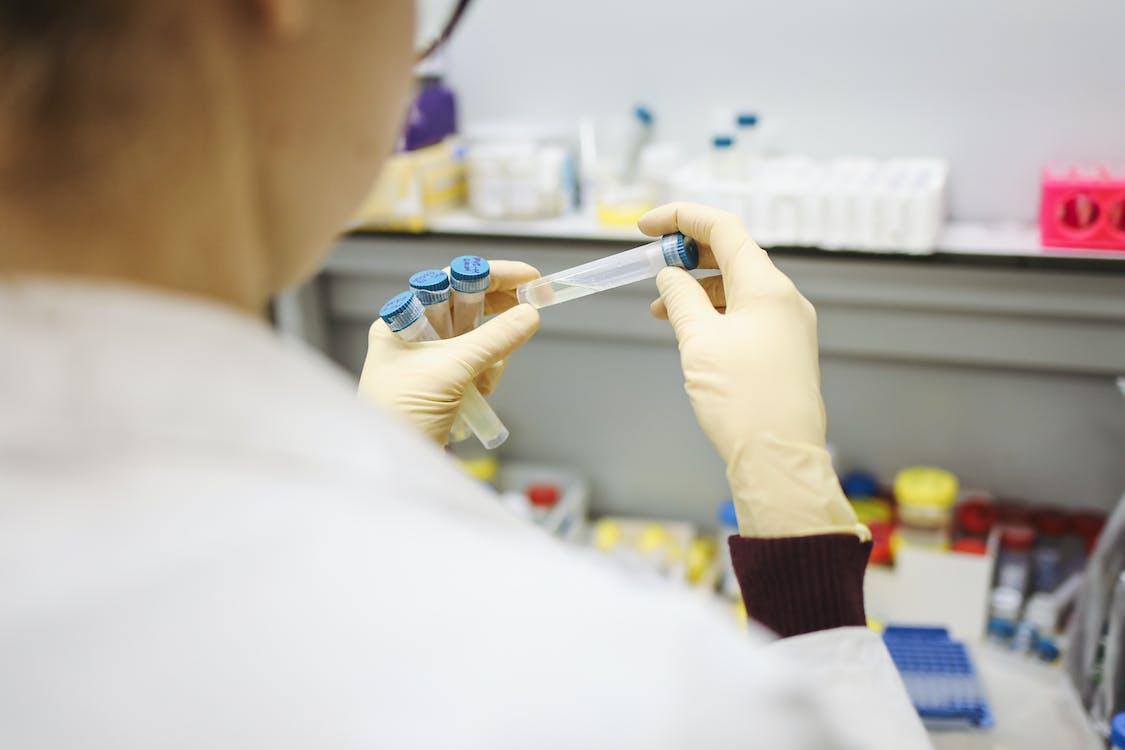 Free Person Holding Test Tubes Stock Photo