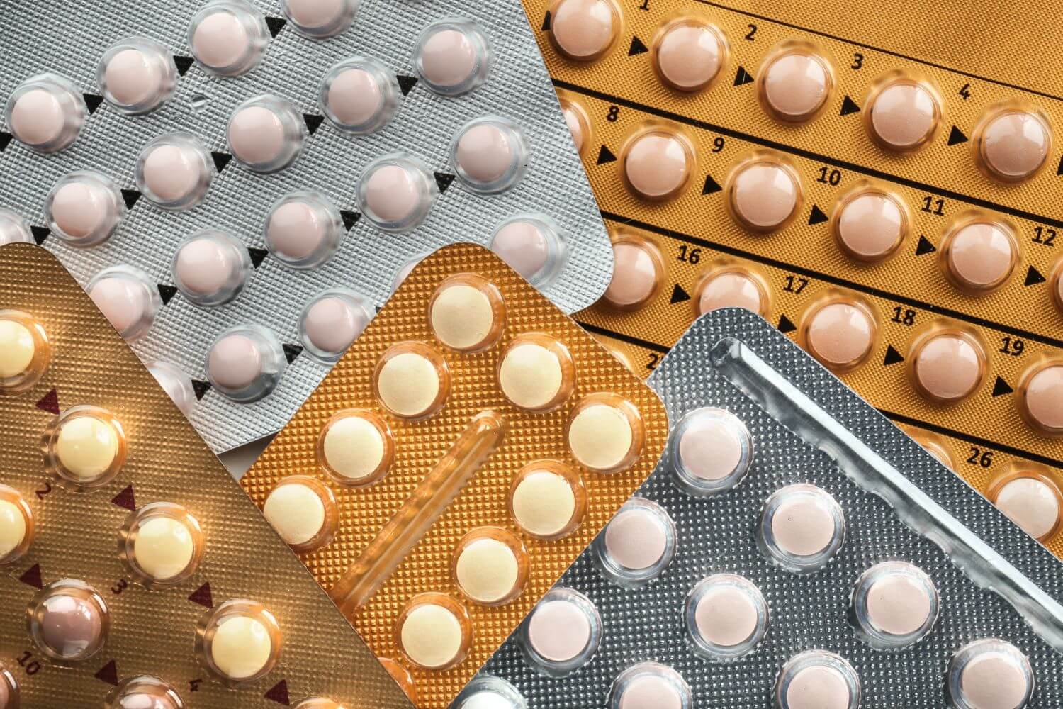 Various types of birth control pills stacked on top of each other