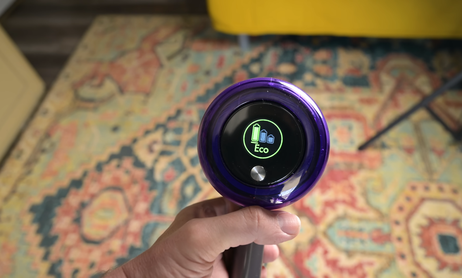 Close-up of the Dyson V11's handle showing the digital display with the battery level indicator set on Eco mode