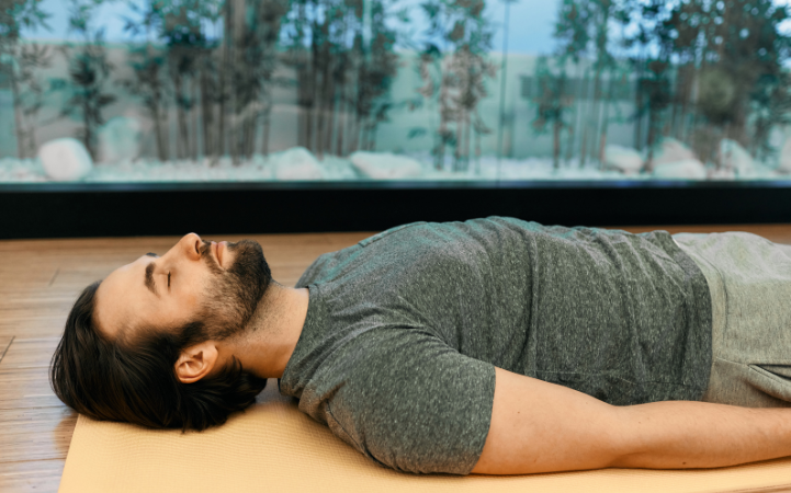 corpse pose on yoga mat