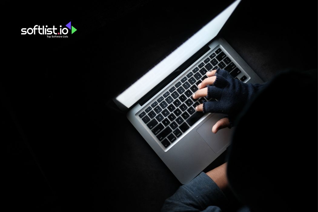 Person using laptop in the dark with Softlist.io logo