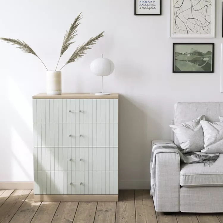 white malm dresser with paneled front and clear pulls. 